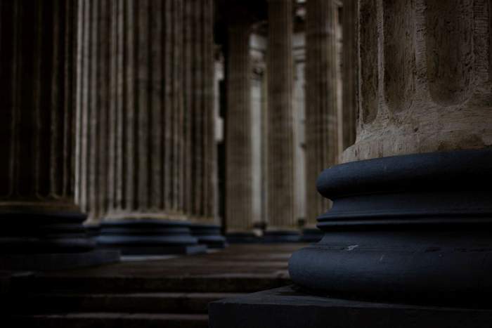 Close-up view of classical stone architectural columns and pillars, symbolizing an institution built to last