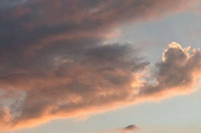Warm sunset clouds glowing orange and pink at dusk